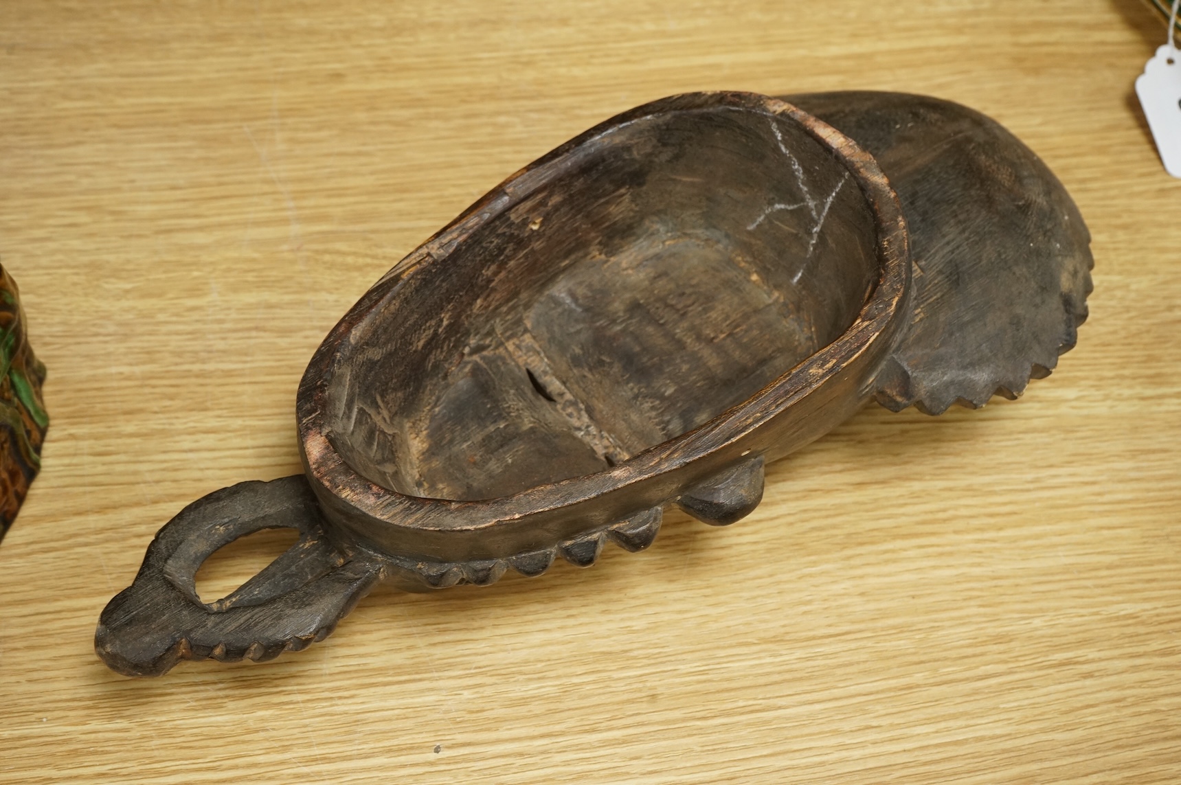 A carved African Guro mask from the Ivory Coast, 40cm long.